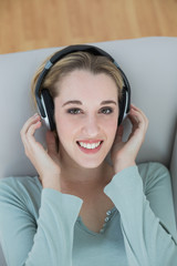 Gorgeous young woman listening with headphones to music smiling