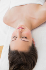 Obraz na płótnie Canvas Brunette on massage table with eyes closed