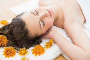 Obraz na płótnie Canvas Brunette lying on massage table in beauty salon