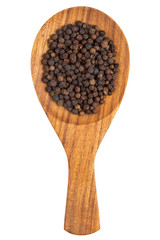 Black pepper (Piper nigrum) peppercorns in the wooden spoon on w