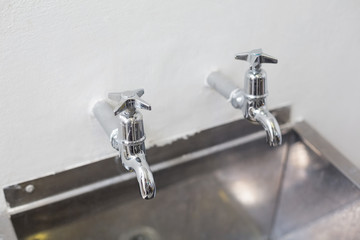 Two taps and stainless steel kitchen sink