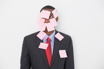 Young Afro businessman covered in blank notes