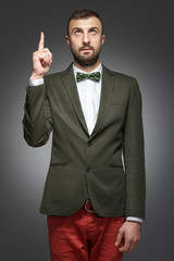 young man in a green suit, shows up