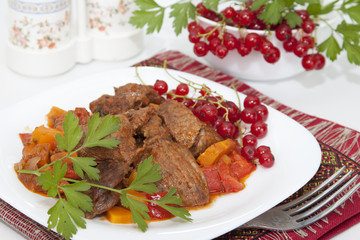 Meat stew with vegetables and red currants