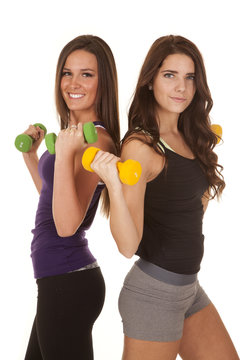 Two women fitness weights back to back
