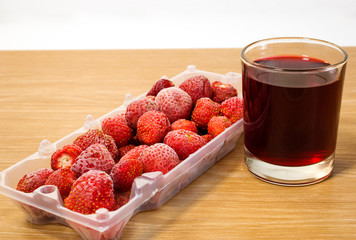 frozen strawberries and juice are on the table