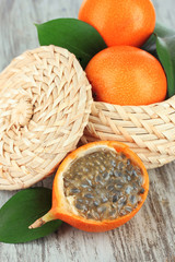 Passion fruits in wicker basket on table close-up