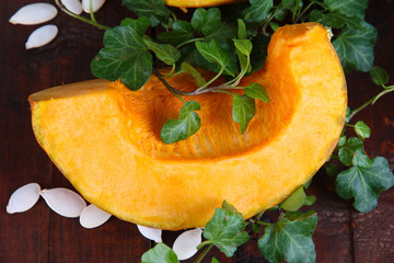 Cut pumpkin on wooden table close-up