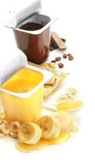 Tasty desserts in open plastic cups and banana, isolated