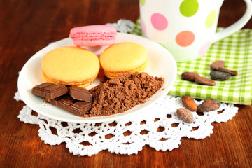 Cocoa in cup with sweets and cocoa powder