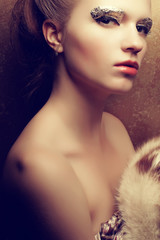 Beautiful young woman undressed holding luxurious furs