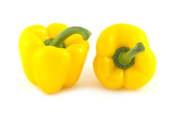 Two big yellow ripe peppers isolated on white closeup