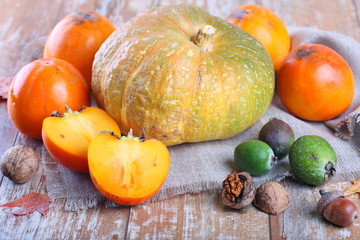 Pumpkin, persimmons and other fruits on the table