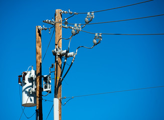 Detailed image of power lines and connections on a wooden post