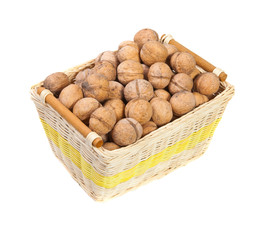 walnuts in a wicker basket on a white background