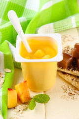 Tasty yogurt with pieces of fresh fruits, cookies and flakes,on