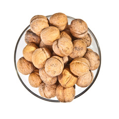 walnuts in a glass dish on a white background