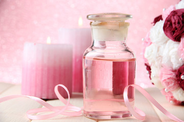 Obraz na płótnie Canvas Glass bottle with color essence, on pink background