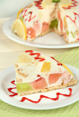 Delicious jelly cake on table on light background
