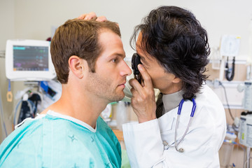 Doctor With Ophthalmoscope Examining Patient's Eye