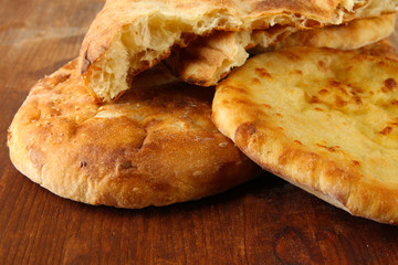 Pita breads on wooden background