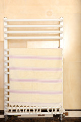 Obraz na płótnie Canvas Color towel on radiator in bathroom