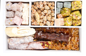 Tasty oriental sweets in wooden crate, close up