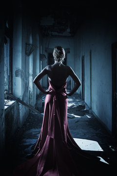 The elegant thin woman in a long dress
