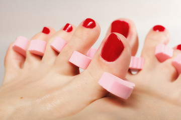 foot pedicure applying red toenails