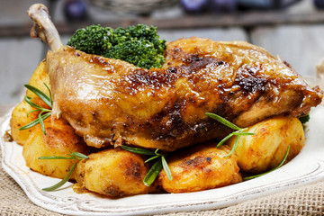 Roasted chicken with vegetables on wooden table