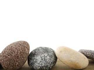 pile of sea stones isolated on board