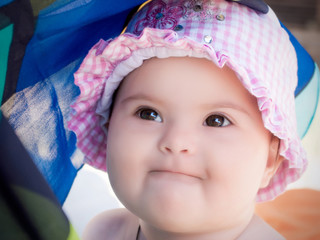 Baby girl wearing a pink hat © _ossa_