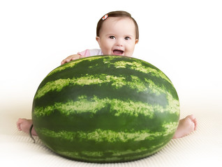 Baby girl with a watermelon smiling