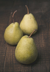 Pears on a rustic wooden kitchen table 