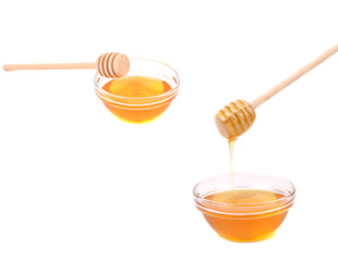 Two bowls with honey and wooden dippers