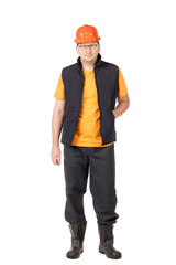 Worker in vest with hard hat and glasses.