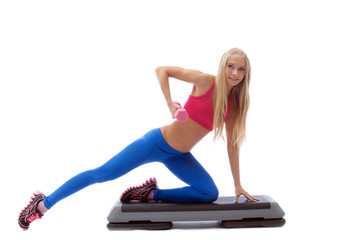 Emotional young blonde doing fitness exercises