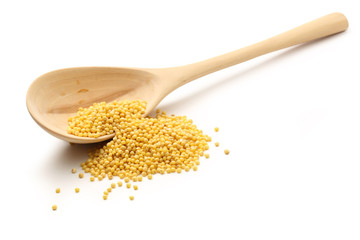 Millet groats with wooden spoon