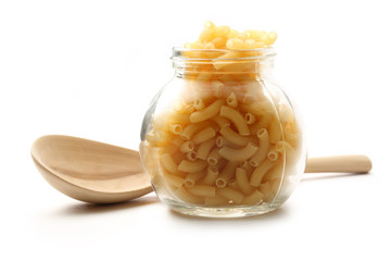 Pasta tubes in jar and spoon