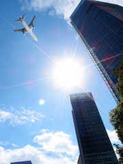 Fototapeta na wymiar airplane flying over buildings