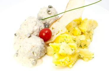 meatballs with potatoes on the table in a restaurant