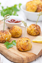 chicken meatballs in corn breading on wooden board