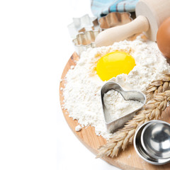 flour, eggs, rolling pin, measuring spoons and baking forms