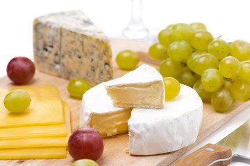 three kinds of cheese and grapes isolated, selective focus
