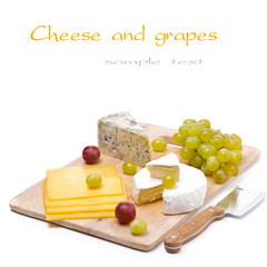 three kinds of cheese and grapes, isolated