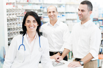 Pharmaceutical attending two customers