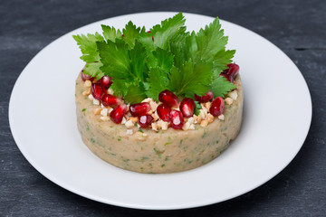 white bean pate with nuts and pomegranate, top view