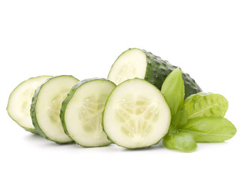 Sliced cucumber vegetable and basil leaves still life