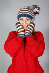 Happy girl is in a hat and mittens