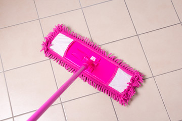Tile floor washing with a mop